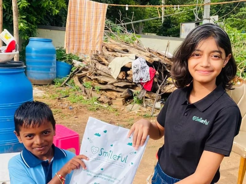 A Smileful volunteer engaging with children in the community